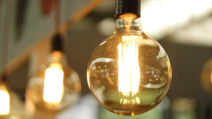 A glowing vintage light bulb hanging indoors