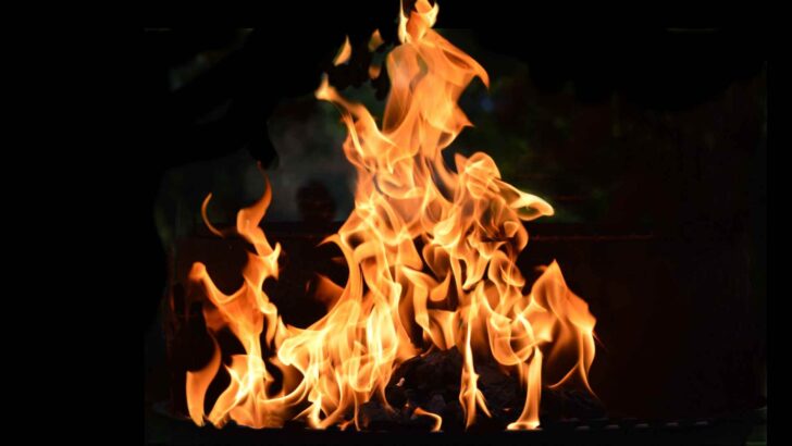 Bright orange flames burning against a black background