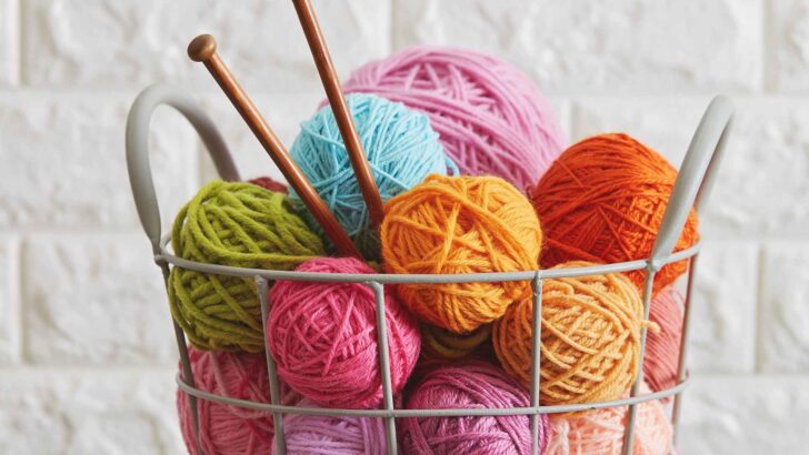 A person knitting with yarn nearby
