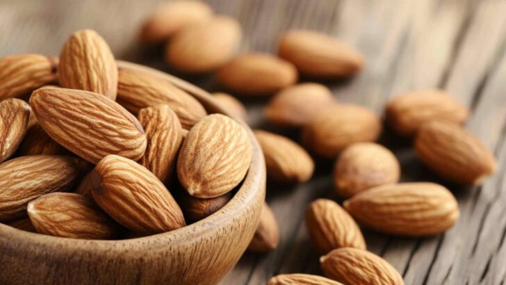 Wooden bowl filled with whole nuts