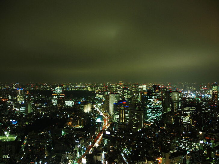 Wide nighttime view of Tokyo's illuminated skyline
