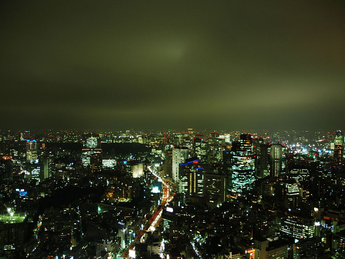 Wide nighttime view of Tokyo's illuminated skyline