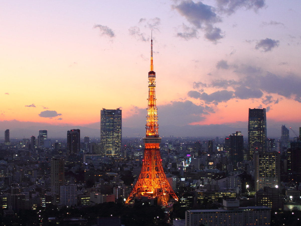 Tokyo Tower glowing orange above the city at sunset