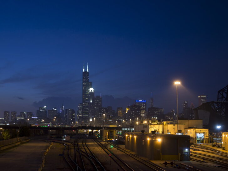 Chicago skyline illuminated at night with Willis Tower visible