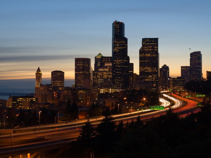 Seattle skyline and freeway light trails at dusk