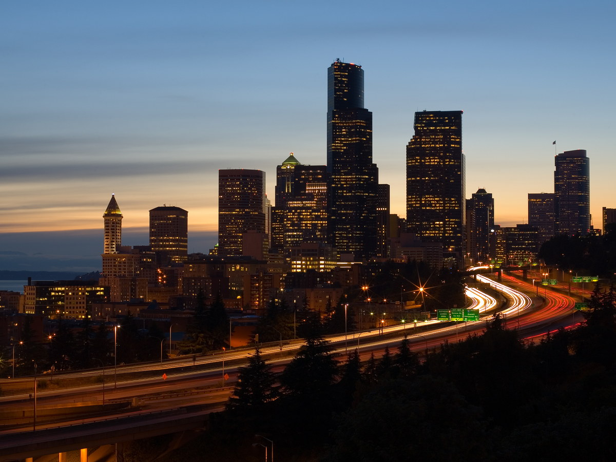 Seattle skyline and freeway light trails at dusk