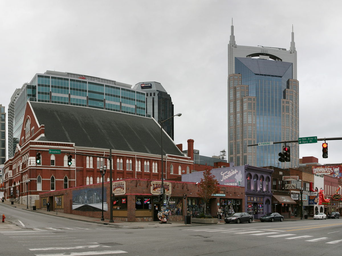 Downtown Nashville skyline rising behind Broadway buildings