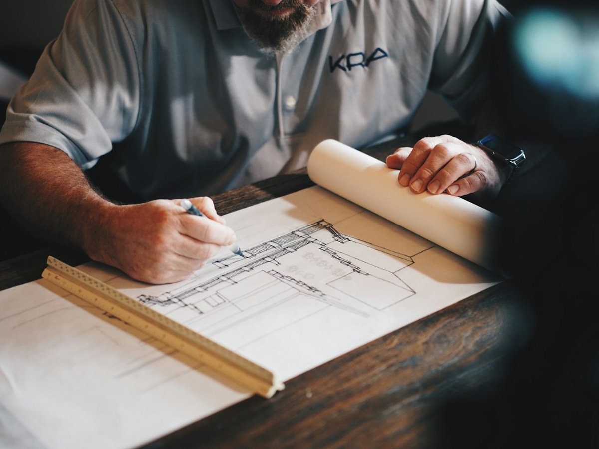 Architect using a pencil and ruler on a building plan