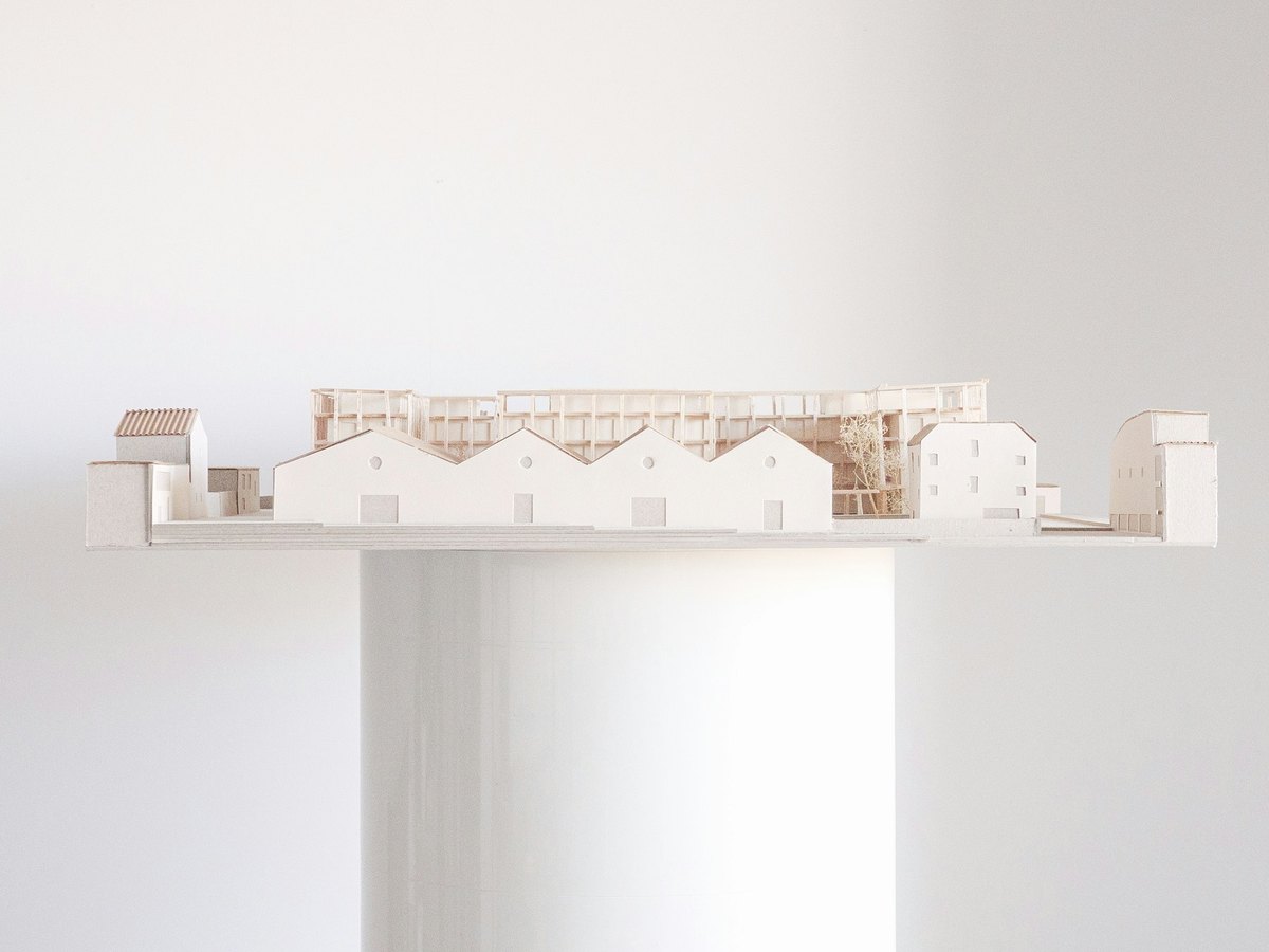 Detailed white architectural building model on display