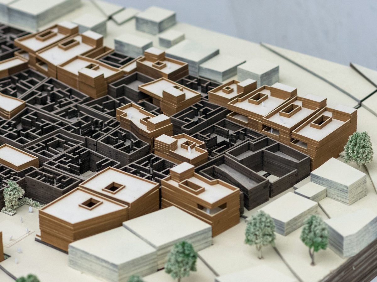 Detailed architectural city model arranged on a design table