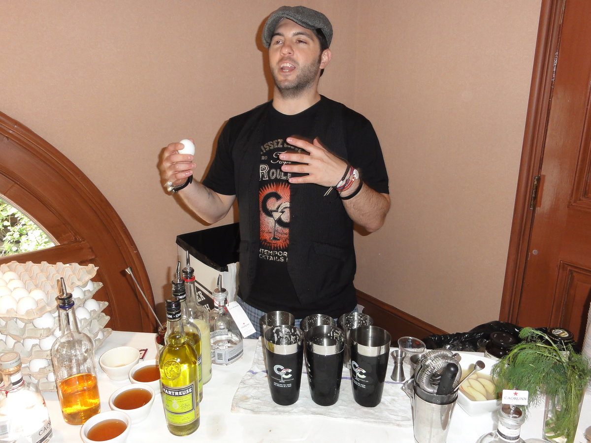 Bartender mixing drinks behind a table