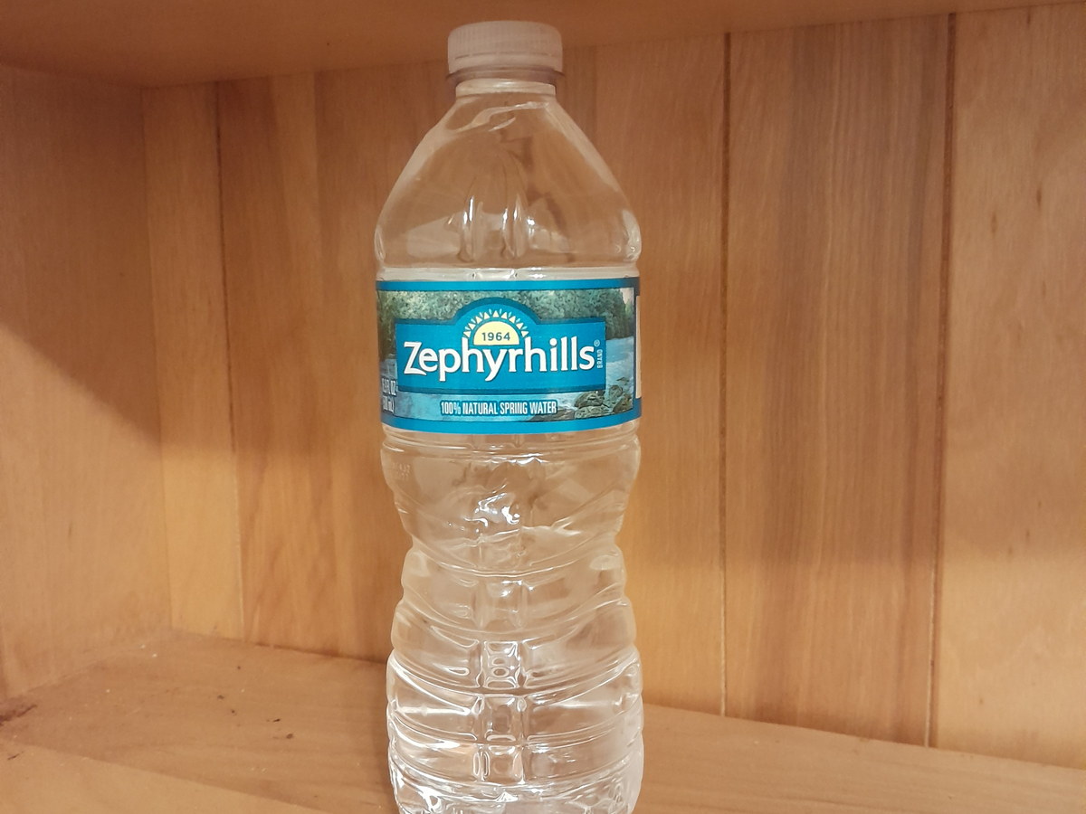 Clear plastic water bottle on a wooden shelf