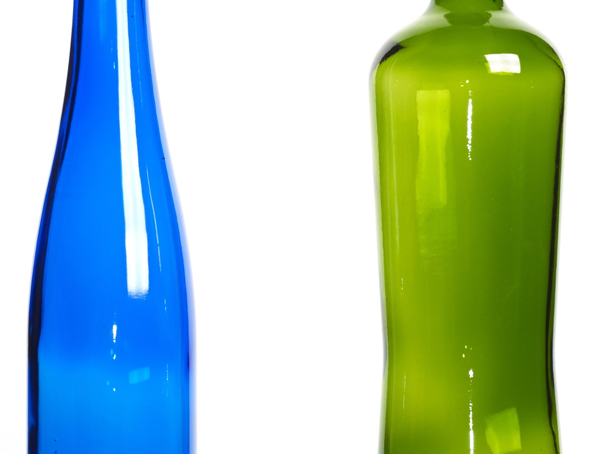 Blue and green glass bottles on a white background