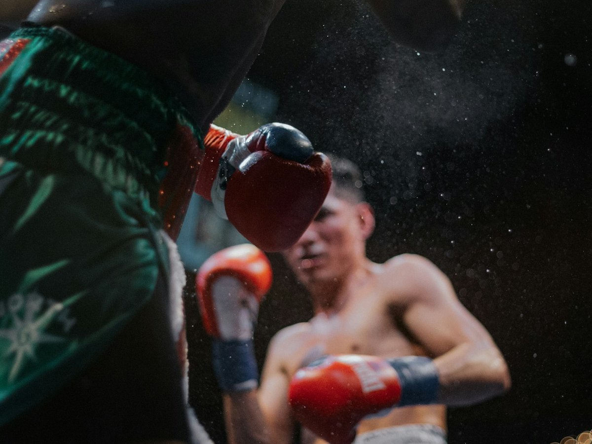 Two boxers exchanging punches in a boxing ring