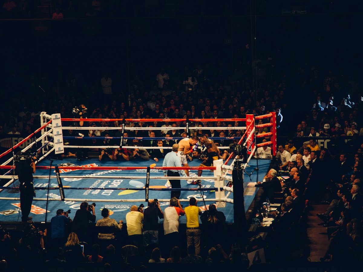 Boxers competing in a brightly lit arena ring