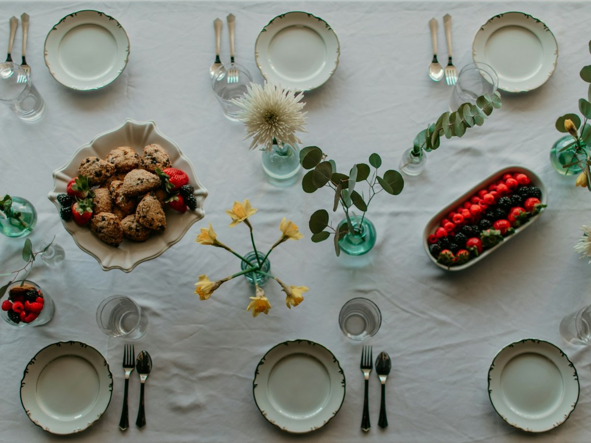 Elegant brunch table arranged with plates and fresh food