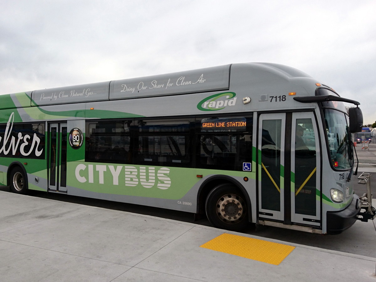 Modern city bus parked at a transit stop