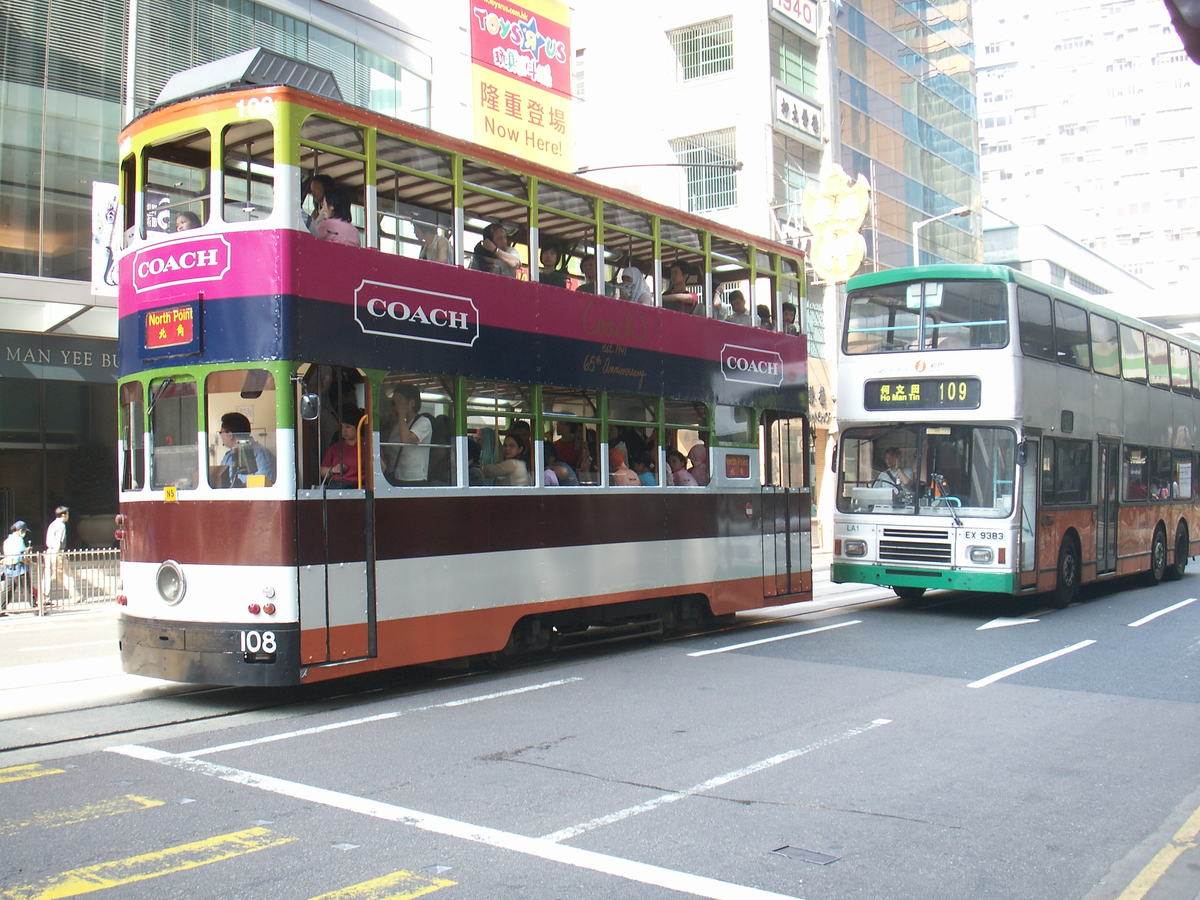 Double-decker buses traveling along a city street
