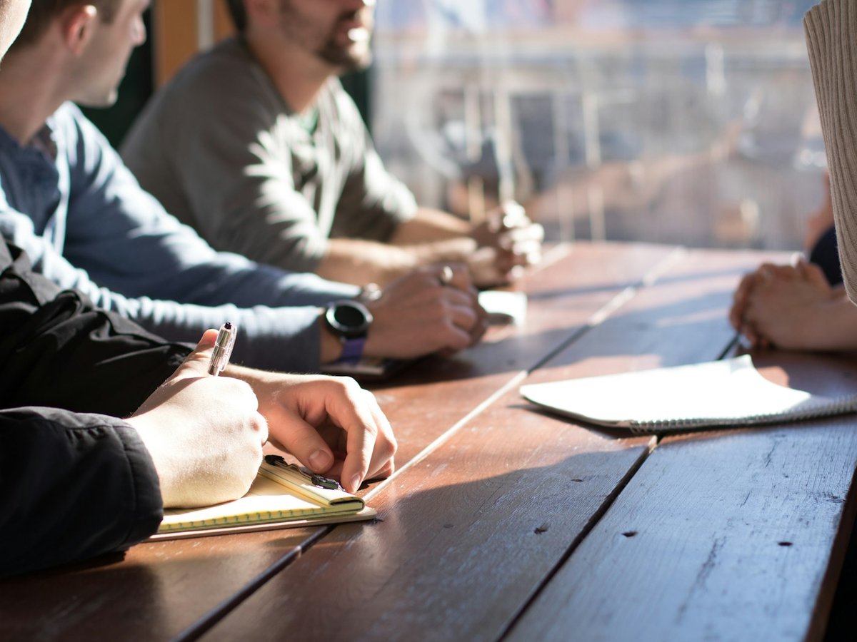 Business professionals taking notes during a meeting