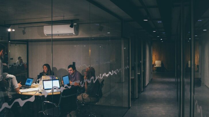 Business team meeting around laptops in a modern office