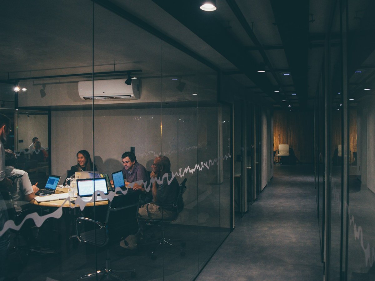 Business team meeting around laptops in a modern office