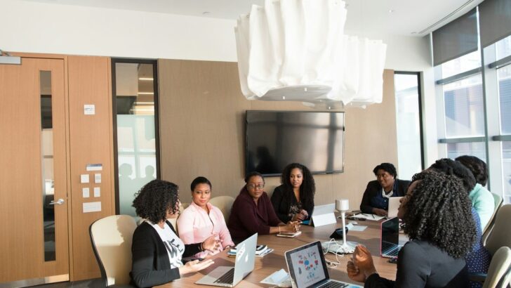 Business team collaborating around a laptop