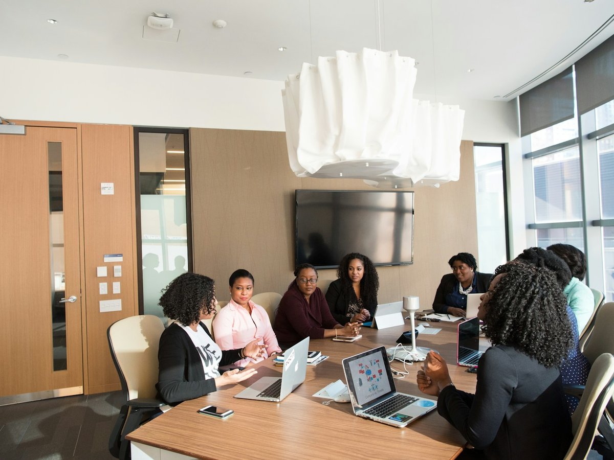 Business team collaborating around a laptop