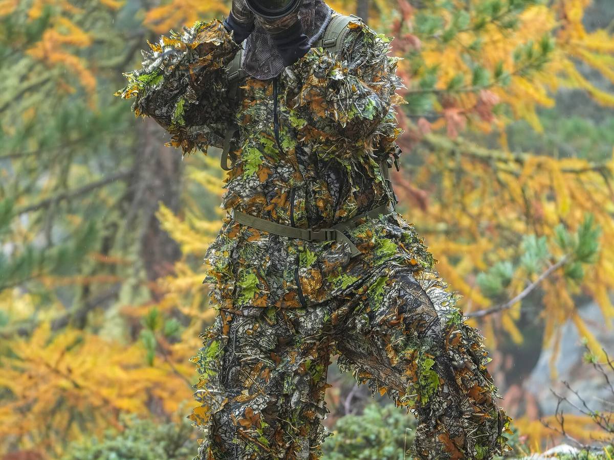 Wildlife photographer dressed in a full camouflage outfit