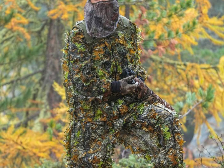 Wildlife photographer wearing camouflage clothing outdoors