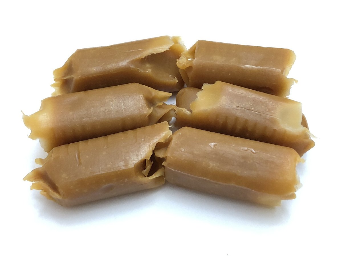 Six chewy caramel candies arranged together