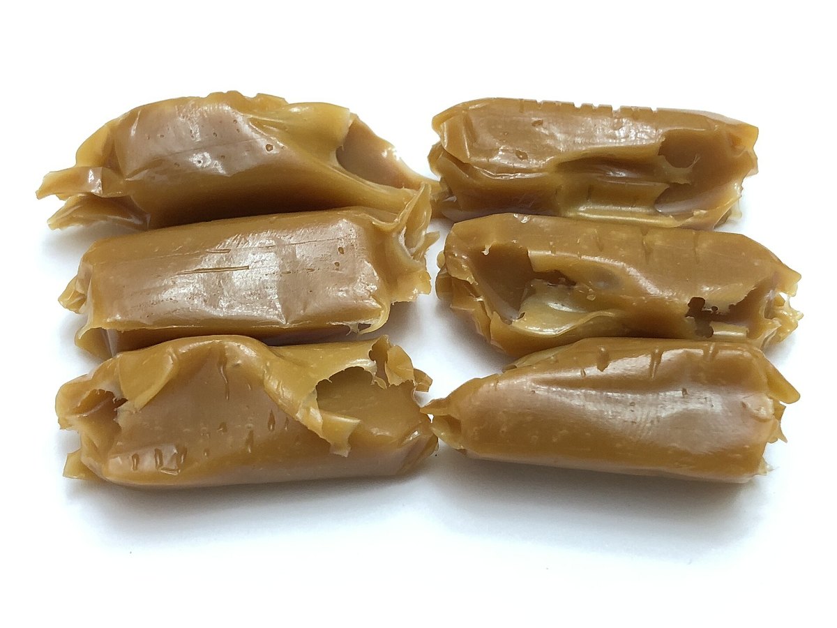 Soft caramel candies unwrapped on a plate