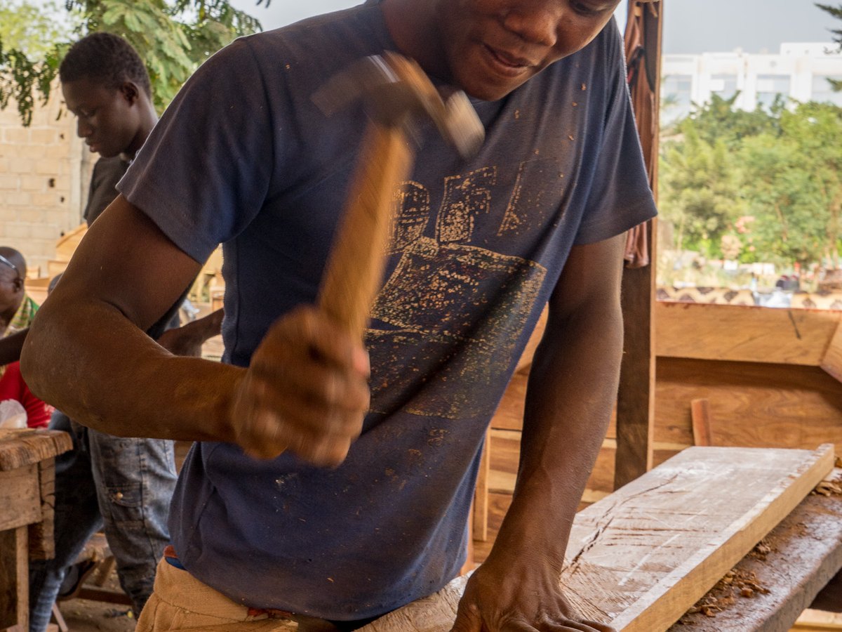 Carpenter working with wood inside a workshop