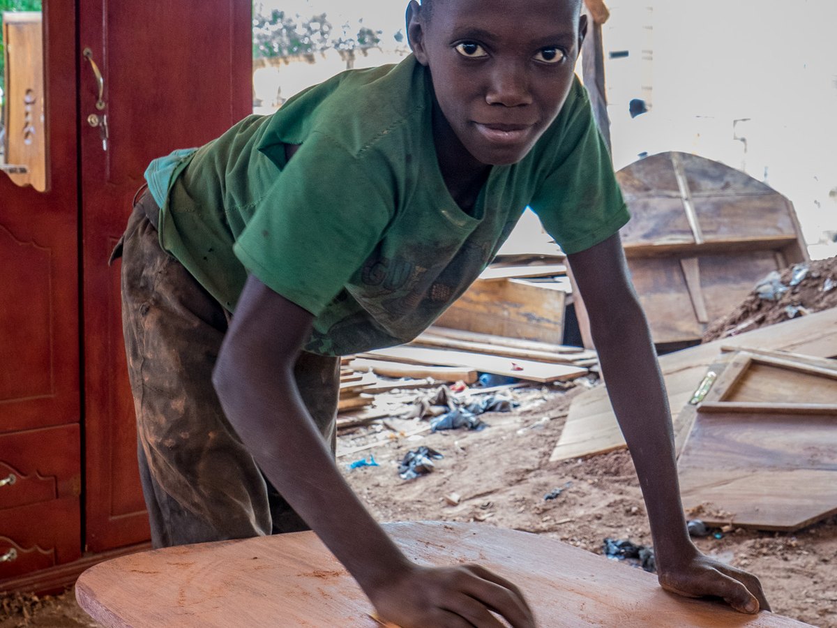 Woodworker shaping timber at a workshop bench