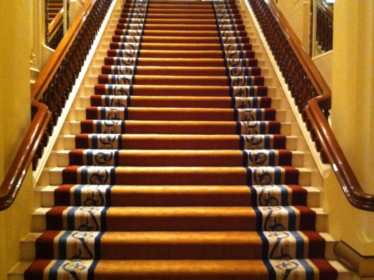 Patterned carpet covering a grand hotel staircase