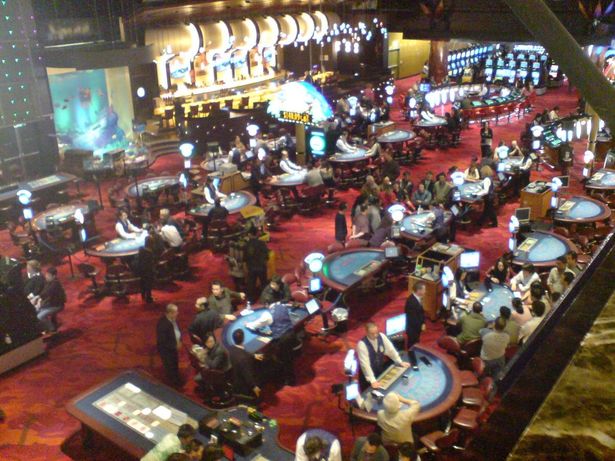 Gaming tables inside a brightly lit casino