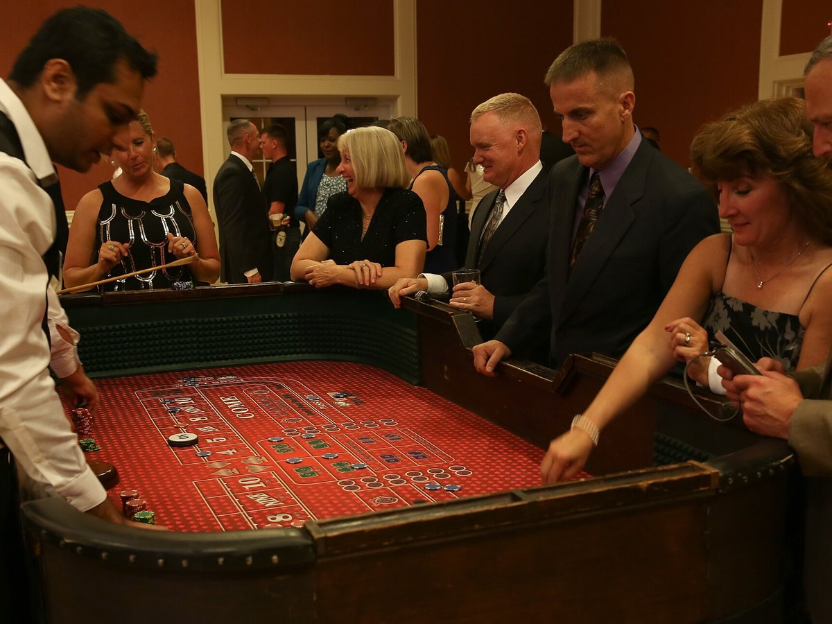 Guests gathered around a roulette table at a casino event