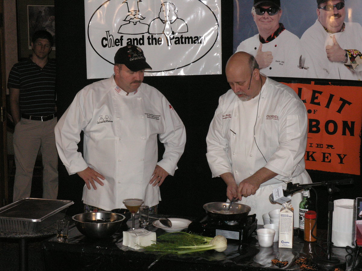 Two chefs preparing food during a cooking demonstration