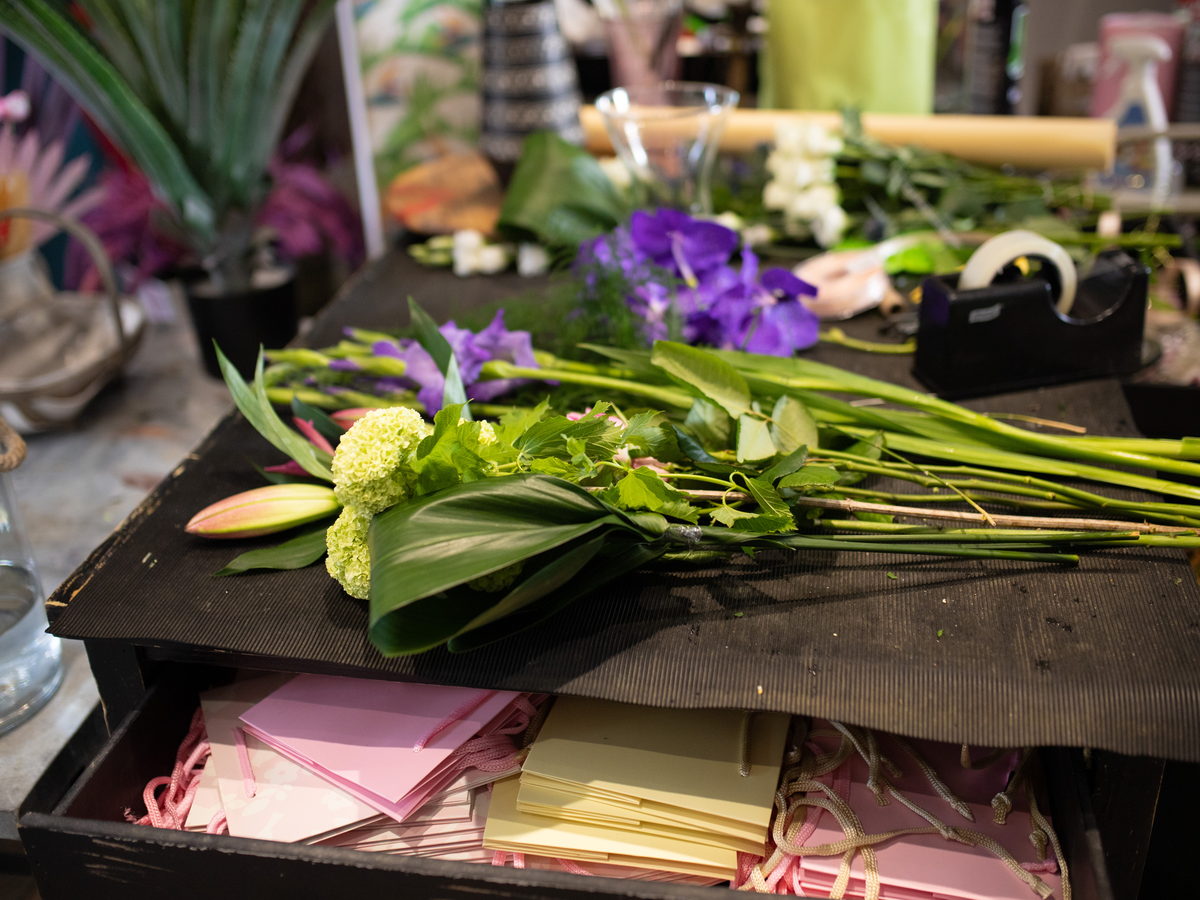 Fresh flowers and floral supplies on a florist worktable