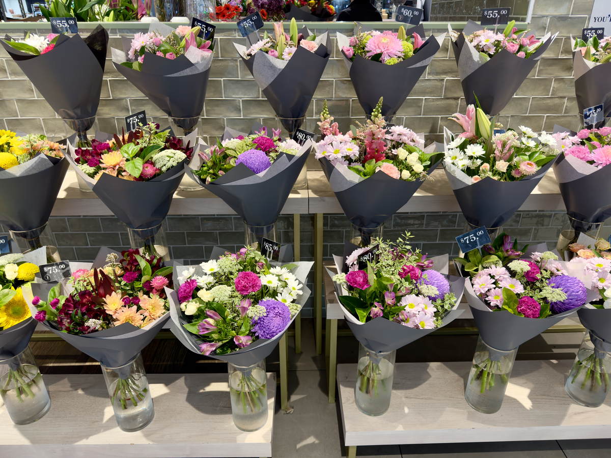 Colorful wrapped bouquets displayed at a flower shop