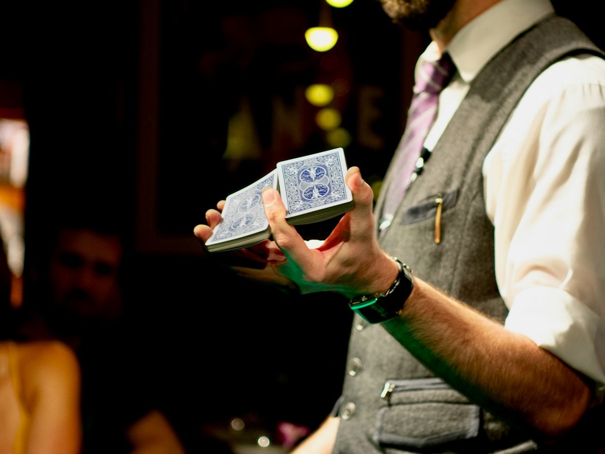 Magician displaying playing cards during a close-up trick