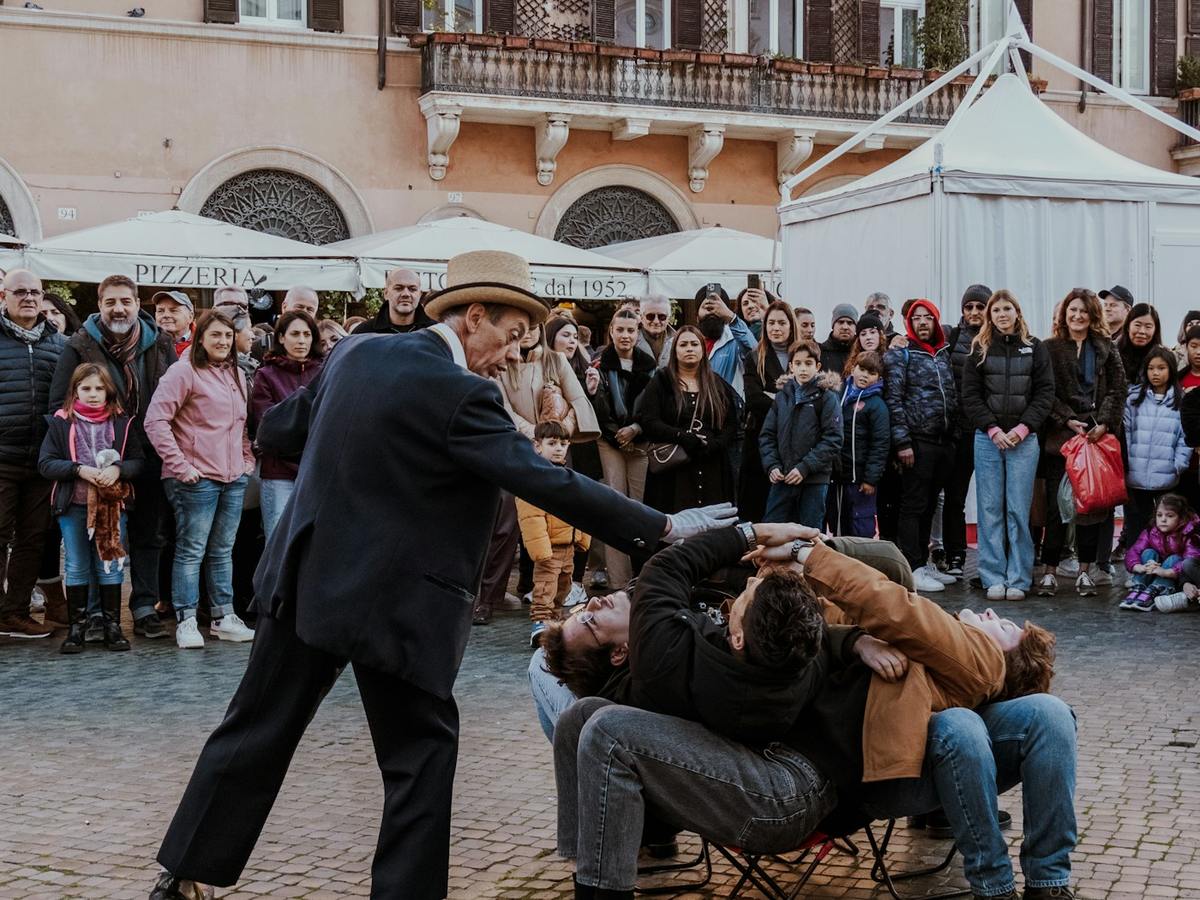 Street magician performing a trick for an outdoor audience
