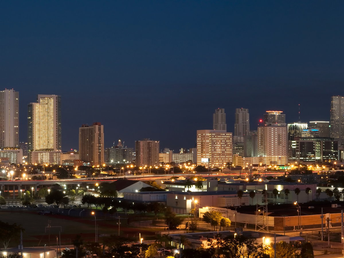 Miami skyline glowing at night across the water