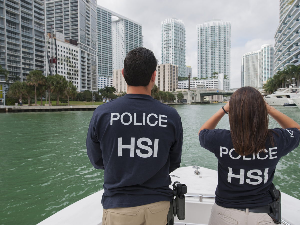 People looking across the Miami waterfront toward high-rise buildings