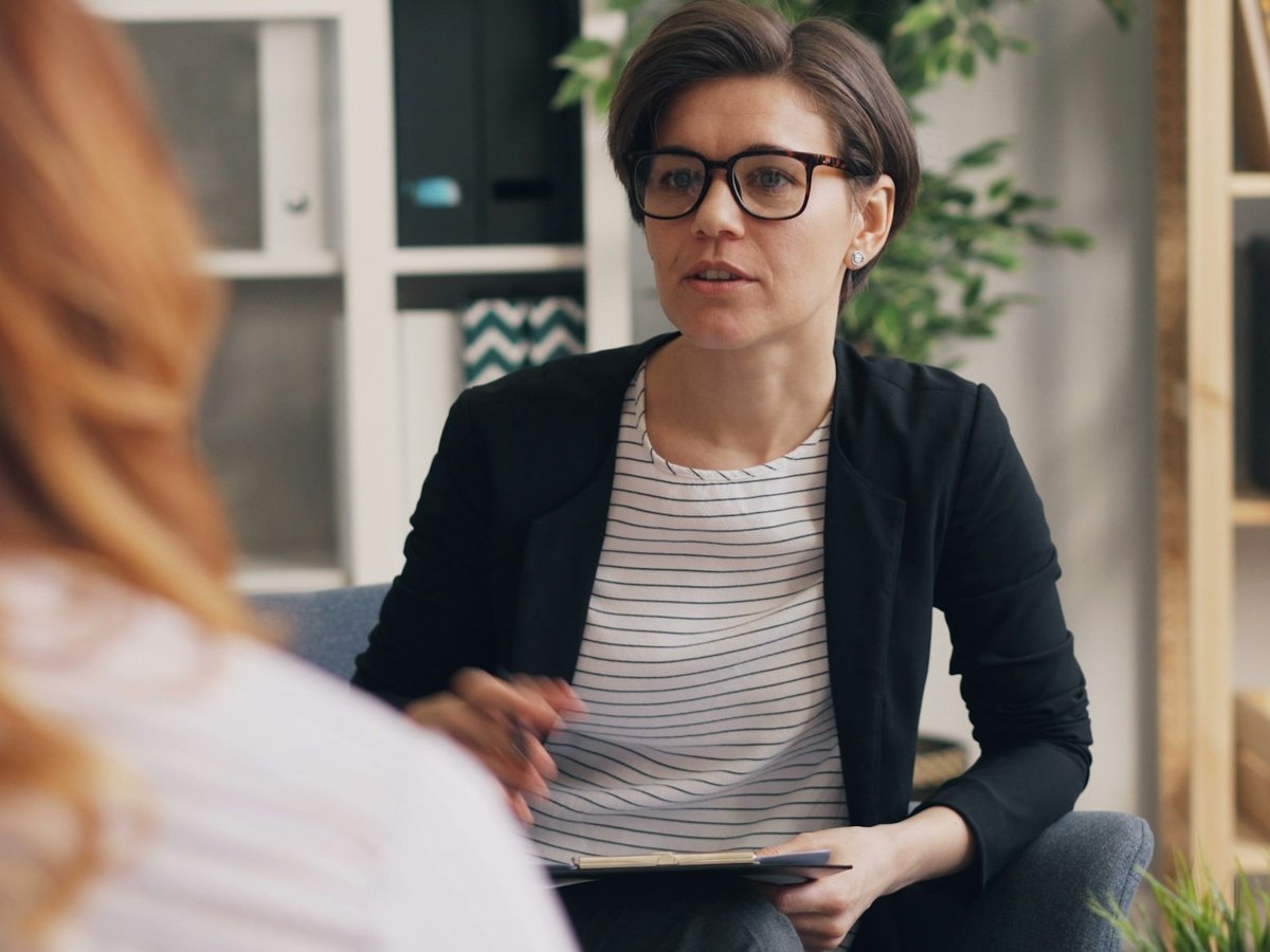 Therapist speaking with a client during an office session